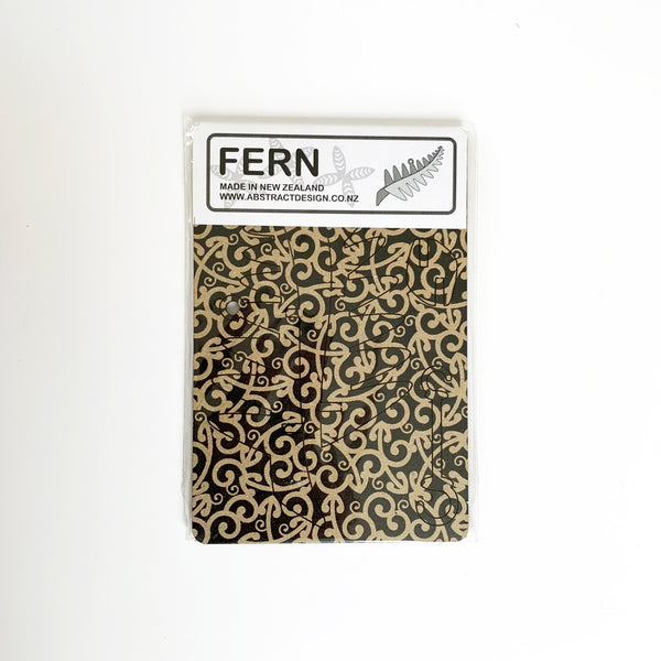 Abstract Design Koru Black Fern Christmas Decoration flatpacked in packaging.