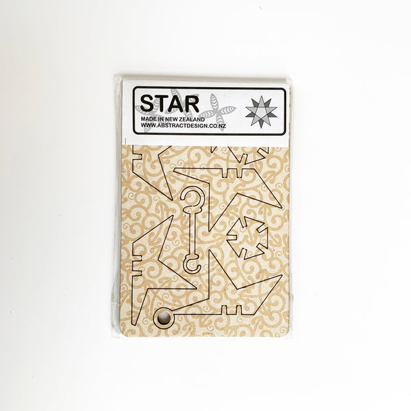 Abstract Design Koru White Star Christmas Decoration flatpacked in packaging.