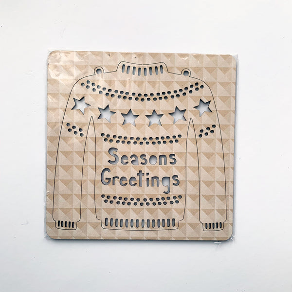 Abstract Design White Geo Seasons Greetings Christmas Jumper in its packaging.