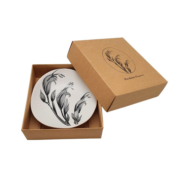 Image of white Harakeke Flower 10cm Bowl in the kraft cardboard gift box that it comes in.