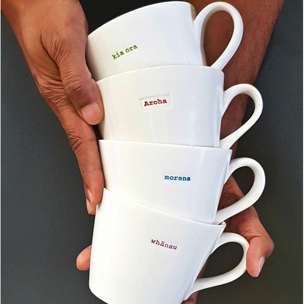 Lifestyle image of hands holding stacked Keith Brymer Jones Te Reo Bucket Mug collection.