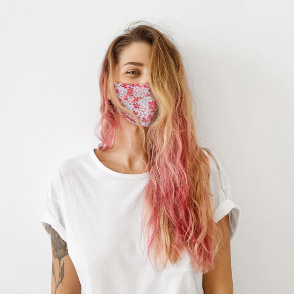 Lifestyle image of model wearing Pink Cherry Blossom MASKit Face Mask.