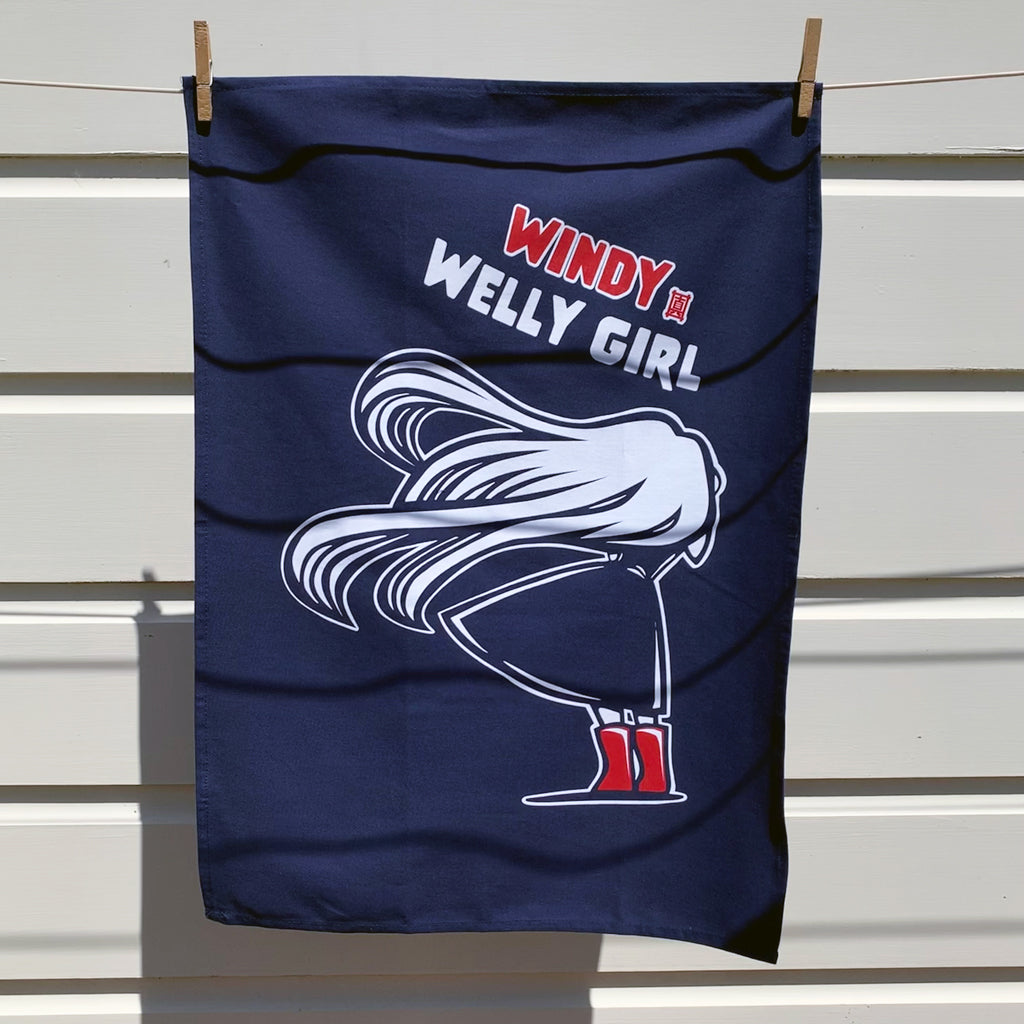 Lifestyle image of Masako Styles Windy Welly Girl with Red Boots Navy Tea Towel hanging on washing line.