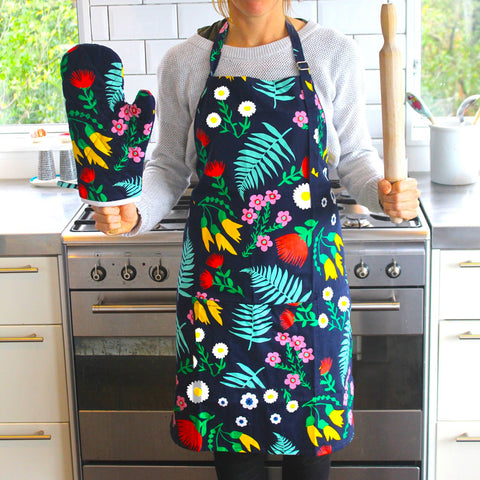 Lifestyle image of model in Moana Road Apron and Mitt Set, Floral.